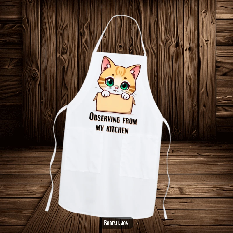 Funny Bobtail Cat Apron featuring a cute cat character peeking with curiosity from inside a box, adding humor to culinary tasks.
