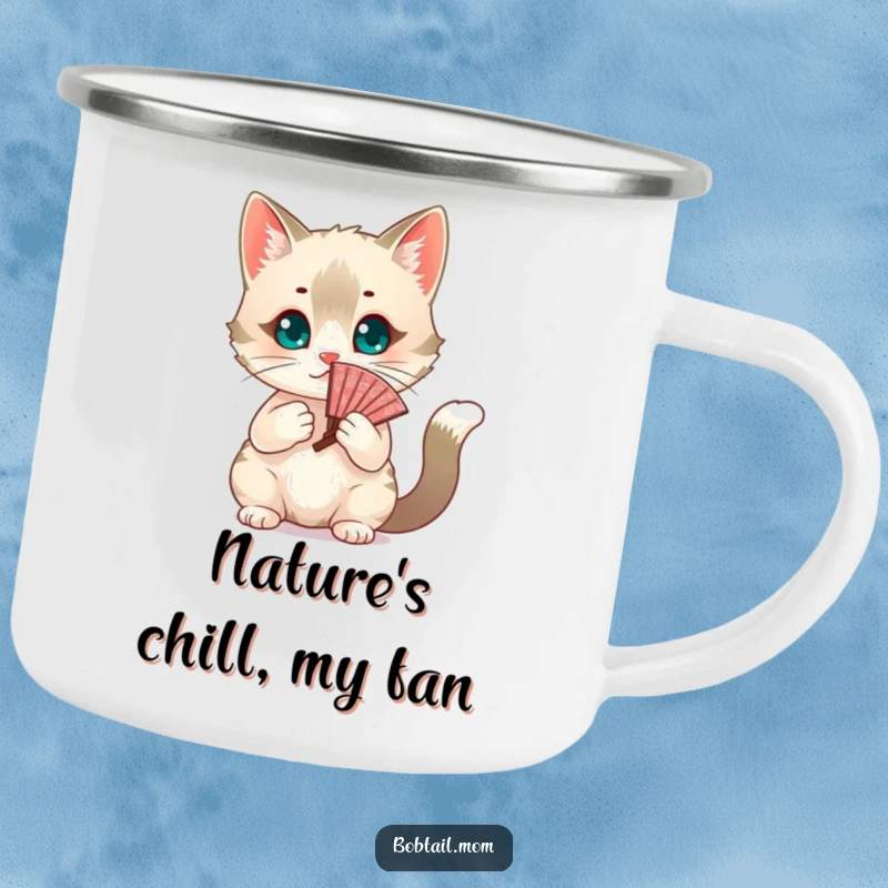 Funny chic Bobtail cat fanning itself with a decorative fan in an outdoor setting. A humorous camping mug, a great gift.