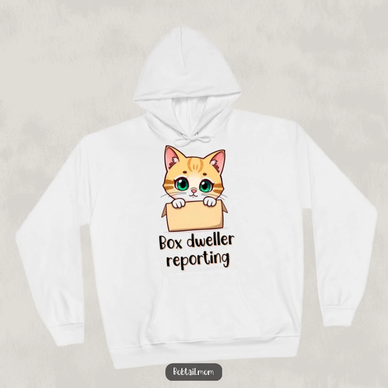 Funny Bobtail Cat Hoodie featuring a cute cat character peeking inquisitively from inside a cardboard box, offering warmth and humor.
