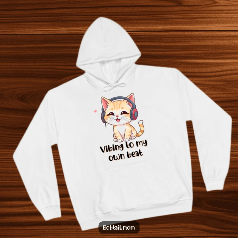 Funny Bobtail Cat Hoodie: Cat wearing headphones, listening to music, combining cozy comfort with musical humor.