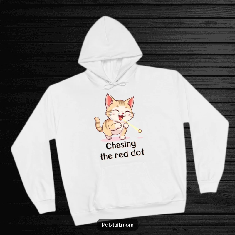 Funny Bobtail cat hoodie with a delighted cat jumping, intensely focused on a tiny laser pointer dot, conveying pure, unadulterated fun.