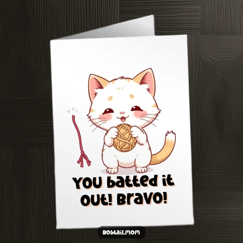 Funny Free Printable Congratulations Card: An energetic Bobtail cat is playfully batting at a swinging ball of yarn.