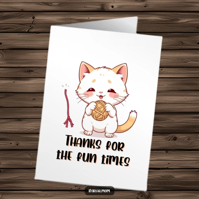 Funny Free Printable Thank You Card: A cute Bobtail cat energetically plays with a dangling ball of colorful yarn.