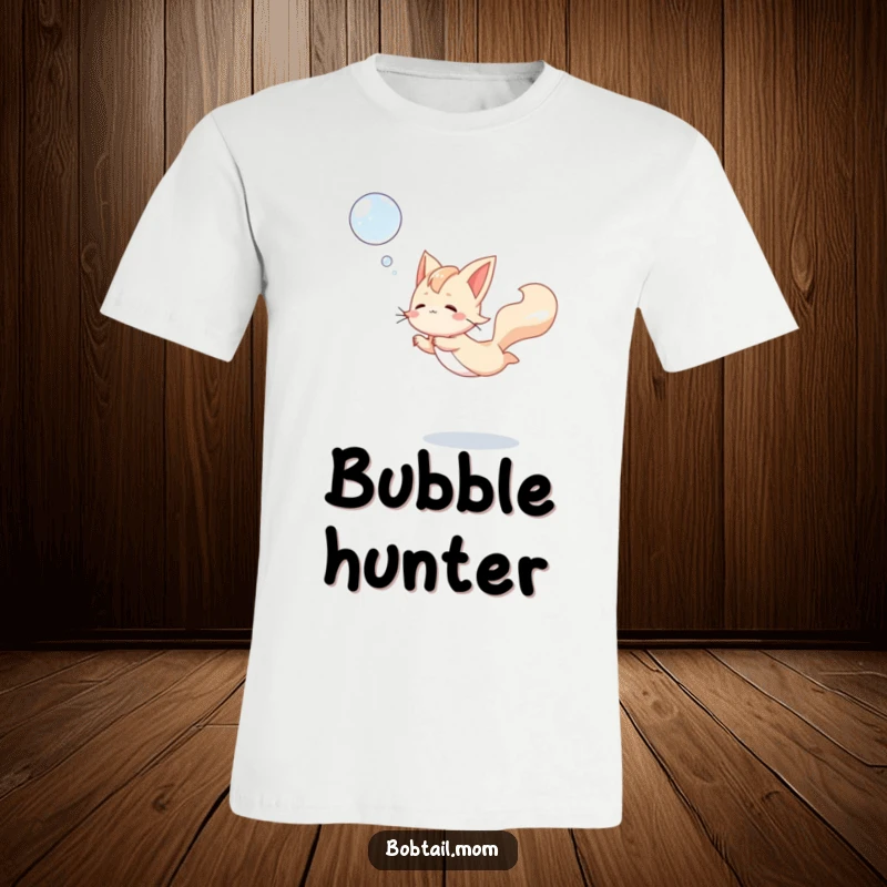 Funny Bobtail T-Shirt showcasing a dog in mid-air, gracefully leaping to catch a shimmering bubble, celebrating playful exuberance.