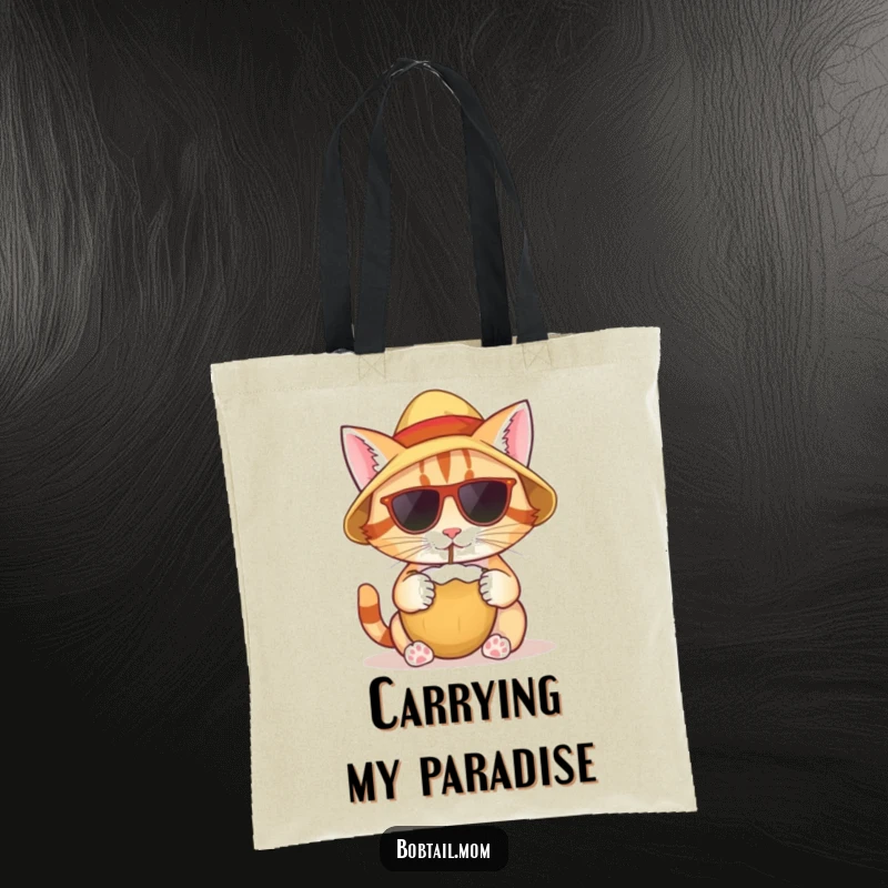 Funny tote bag featuring a bobtail cat with a sun hat, sipping from a coconut, ready for beach adventures.