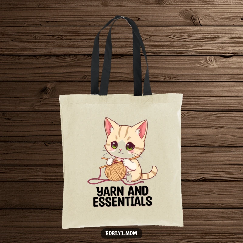 Funny bobtail cat with a knitting needle and yarn, looking focused, perfect for a humorous and practical tote bag for knitters.