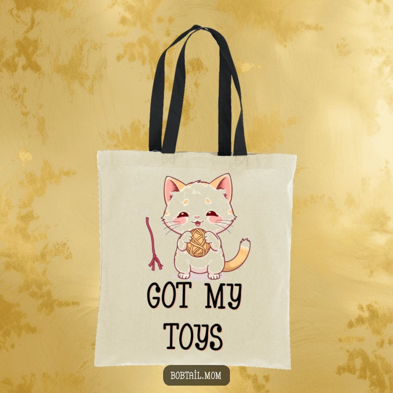 Funny tote bag with a playful Bobtail cat batting at a dangling yarn ball, a perfect accessory for cat lovers.